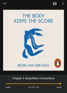 Audible book cover of The body keeps the score.